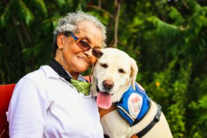 A senior citizen with a dog, one of the low maintenance pets for elders