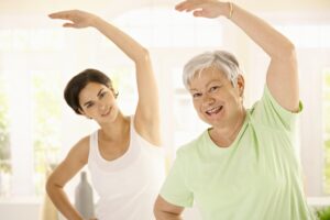 An image of 2 women doing fall prevention balance exercises for seniors.