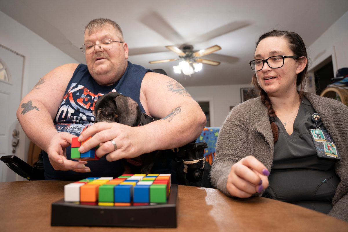 Firefly caregiver, Kaylee, plays a game with her client.